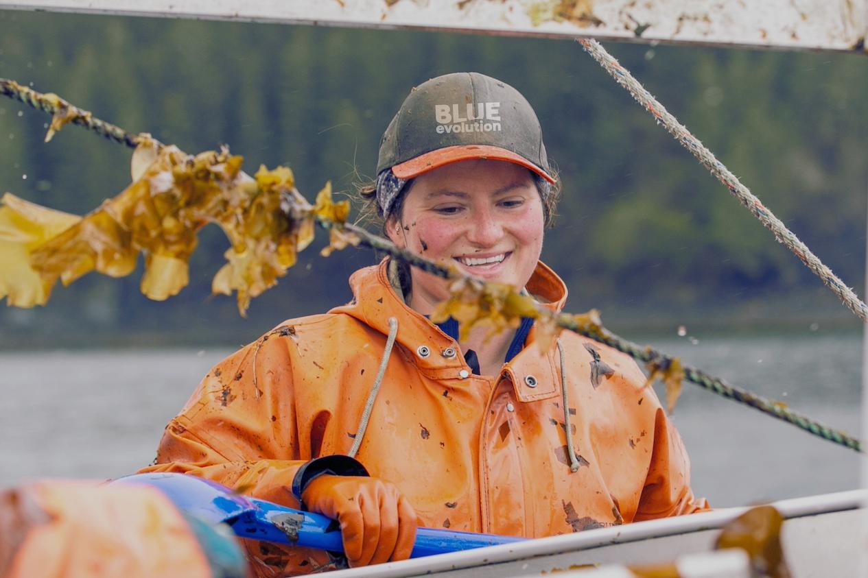 A Blue Evolution employee on a seaweed harvesting boat — seaweed farming